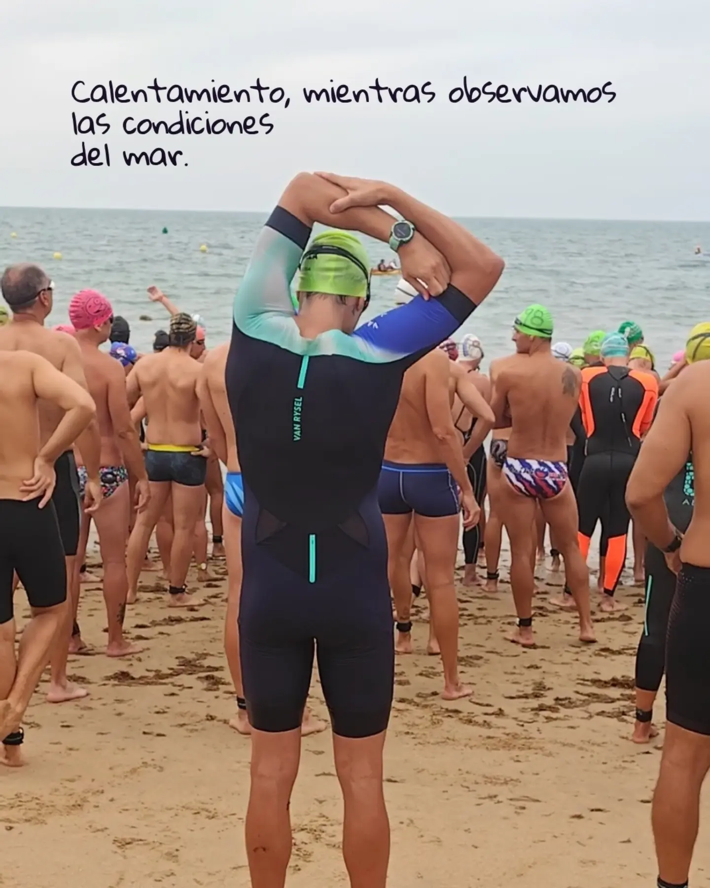 Warm-up on the sand alongside other swimmers before entering the sea.